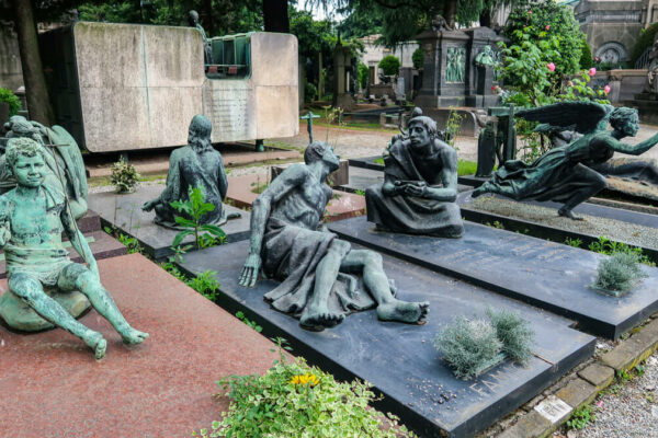 Skulpturen am Monumentefriedhof: leidende Menschen auf Gräbern